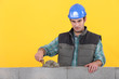 Man with trowel spreading cement on wall