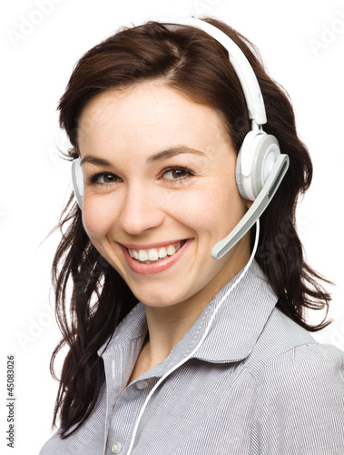 Photo: Lovely young woman is talking to customers Lovely young woman is talking to customers
