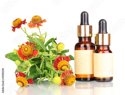 Photo: medicine bottles and flowers isolated on white medicine bottles and flowers isolated on white