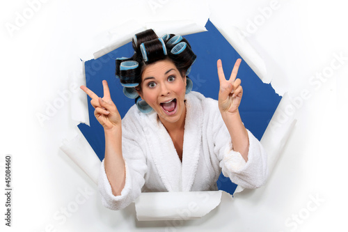Photo: Crazy girl gesturing with bathrobe and hair curlers Crazy girl gesturing with bathrobe and hair curlers