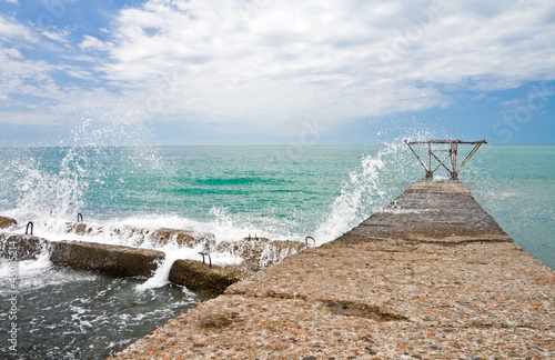 Photo: Breaking wave with sparks on the Black Sea coast. Sochi, Russia Breaking wave with sparks on the Black Sea coast. Sochi, Russia