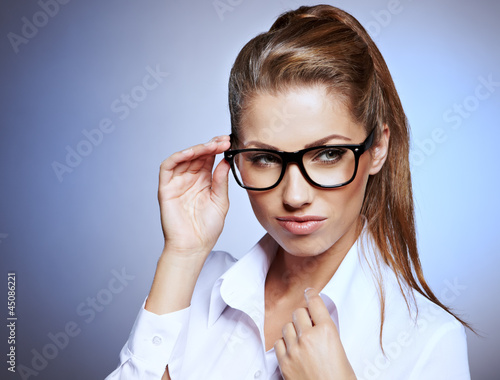 Photo: Cute young business woman with glasses Cute young business woman with glasses