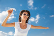 Foto: Young caucasian girl with paper plane Young caucasian girl with paper plane