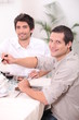 Photo: two young men having lunch two young men having lunch