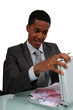 A con man opening a case full of money
