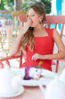 Photo: woman sitting in the cafe and yawning woman sitting in the cafe and yawning