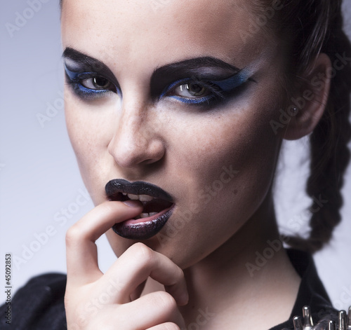 Photo: Fashion beauty. Creative woman violet make up, colorful face-art Fashion beauty. Creative woman violet make up, colorful face-art