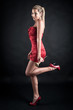 Photo: Beautiful woman with golden make up and red dress Beautiful woman with golden make up and red dress