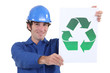 Workman with a recycle sign