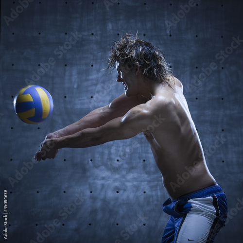 Photo: Studio shot of volleyball player playing Studio shot of volleyball player playing