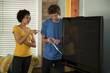 Photo: "USA, Utah, Provo, couple installing new TV set" "USA, Utah, Provo, couple installing new TV set"