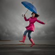 "USA, Utah, Orem, woman with umbrella jumping under overcast sky"