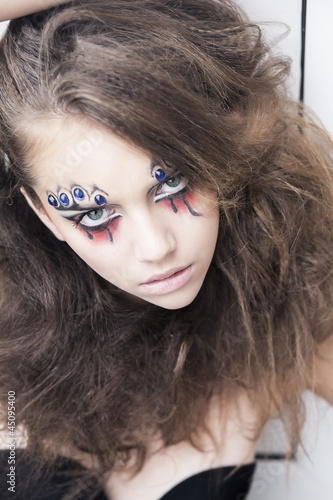 Photo: Young woman with creative face-art - carnival fantasy Young woman with creative face-art - carnival fantasy