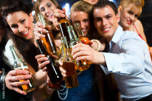 Photo: People in club or bar drinking beer People in club or bar drinking beer