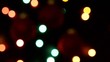 Color video of blurred Christmas lights at night.