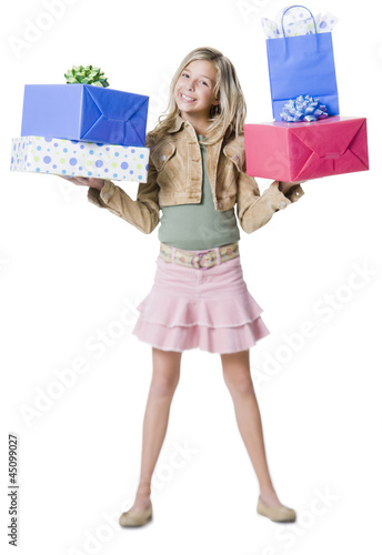 Photo: "Girl (10--11) standing with gifts, portrait" "Girl (10--11) standing with gifts, portrait"