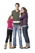 Photo: "Portrait of young man with teenage girl (16-17) and primary age girl (8-9), studio shot" "Portrait of young man with teenage girl (16-17) and primary age girl (8-9), studio shot"