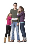 Photo: "Portrait of young man with teenage girl (16-17) and primary age girl (8-9), studio shot" "Portrait of young man with teenage girl (16-17) and primary age girl (8-9), studio shot"