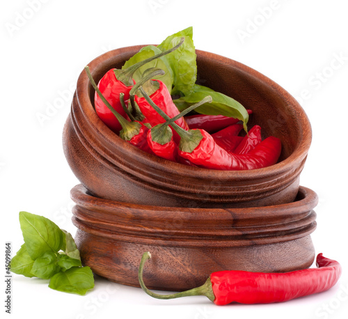 Photo: Hot red chili or chilli pepper in wooden bowls stack Hot red chili or chilli pepper in wooden bowls stack