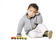 Studio portrait of boy (18-23 months) playing with toy car