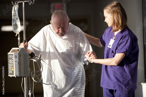 Photo: "USA, Utah, Provo, female nurse helping senior man in hospital" "USA, Utah, Provo, female nurse helping senior man in hospital"