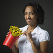 Studio shot of mid adult woman holding patch with yellow measure taps and smiling