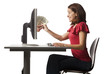 Conceptual picture of young woman receiving paper money out of her computer