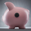 Studio shot of piggy bank with combination lock