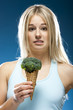 Studio portrait of young woman holding broccoli ice cream