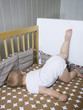 "USA, Utah, Provo, Baby boy (18-23 months) lying in crib"
