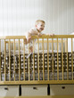 "USA, Utah, Provo, baby boy (18-23 months) standing in crib"