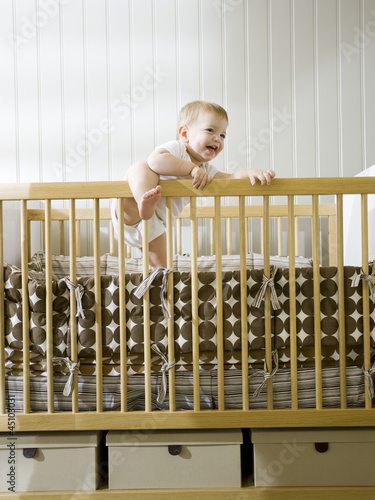 Photo: "USA, Utah, Provo, baby boy (18-23 months) standing in crib" "USA, Utah, Provo, baby boy (18-23 months) standing in crib"
