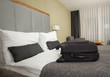 luggage in the beds of a hotel room  
