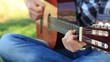 young man play guitar