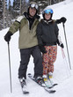 Portrait of father and daughter (12-13) skiing