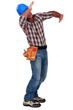 Tradesman using his arms to block a blow