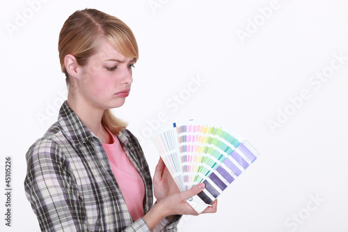Photo: craftswoman painter holding a color chart craftswoman painter holding a color chart