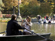 Photo: USA, New York City, Manhattan, Central Park, Mature woman photographing man in boat in Central Park USA, New York City, Manhattan, Central Park, Mature woman photographing man in boat in Central Park