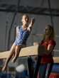 USA, Utah, Orem, girl (10-11) exercising on balance beam with teacher