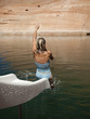 "USA, Utah, Woman splashing in Lake Powell"