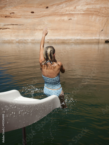 Photo: "USA, Utah, Woman splashing in Lake Powell" "USA, Utah, Woman splashing in Lake Powell"