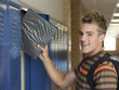 "USA, Utah, Spanish Fork, Portrait of school boy (16-17) taking file from locker"