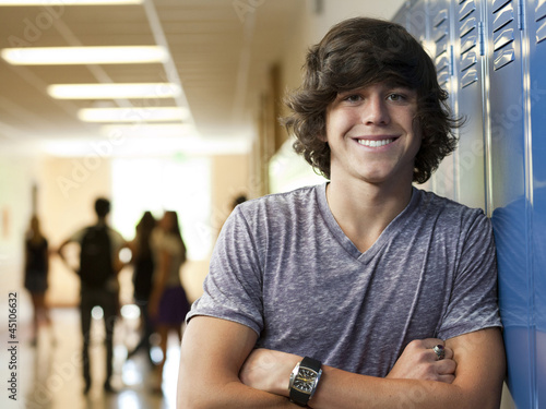 Photo: "USA, Utah, Portrait of young man in school corridor" "USA, Utah, Portrait of young man in school corridor"