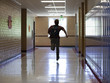 "USA, Utah, Spanish Fork, School boy (16-17) running in corridor"