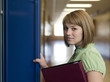 "USA, Utah, Spanish Fork, Portrait of school girl (16-17) holding file by locker"