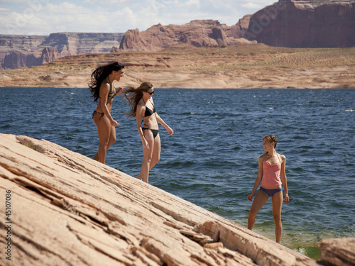 Photo: "USA, Utah, Lake Powell, Three young women in bikini on lakeshore" "USA, Utah, Lake Powell, Three young women in bikini on lakeshore"