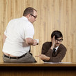 Businessman ignoring colleague at desk in office