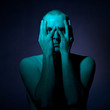 Portrait of young man with hands over face
