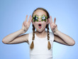 Studio portrait of girl (10-11) wearing star shaped glasses cheering