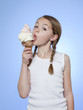 Studio shot of girl (10-11) eating ice-cream